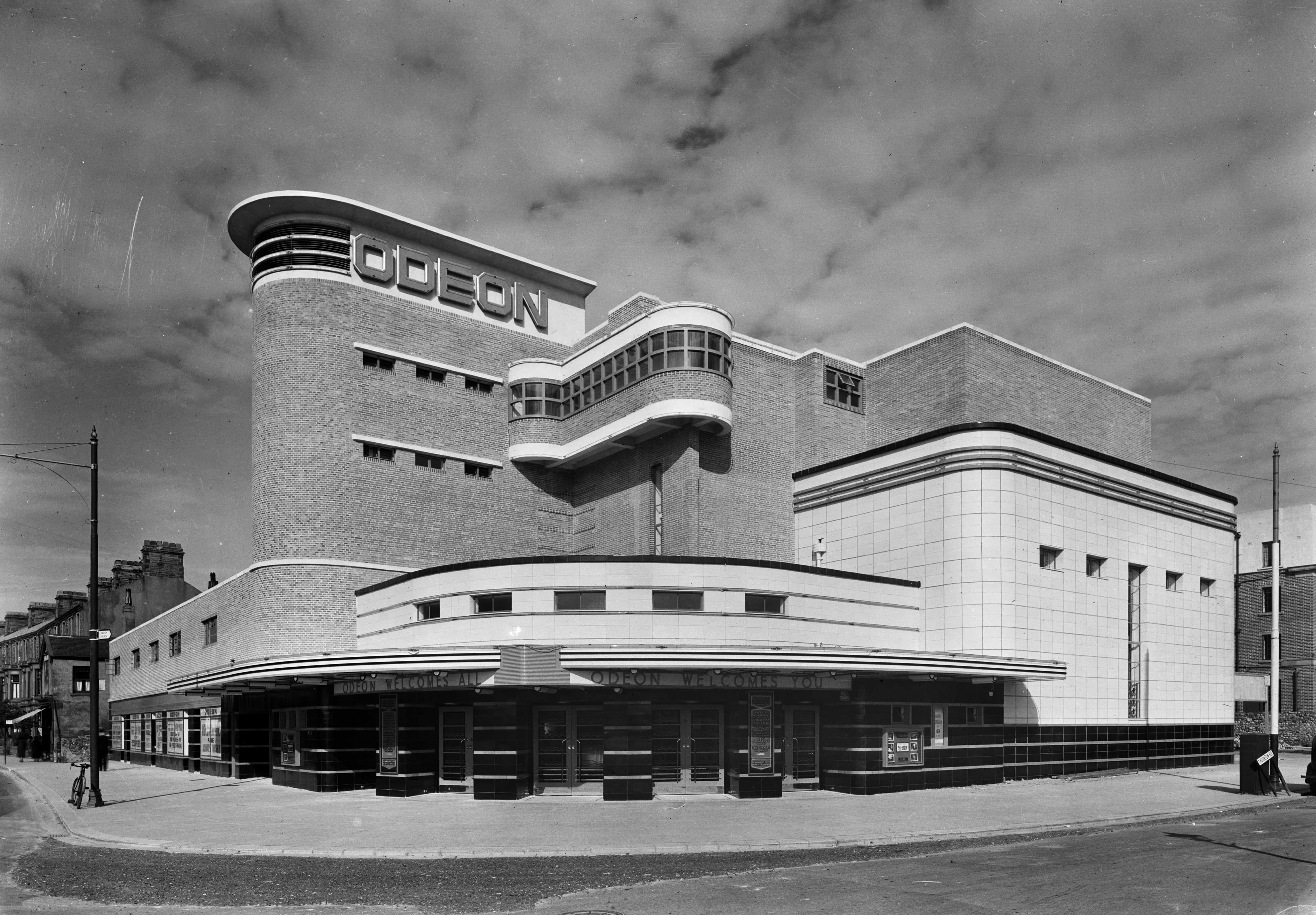 a black and white image of an old odeon cinema