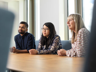 Three people sitting at a table