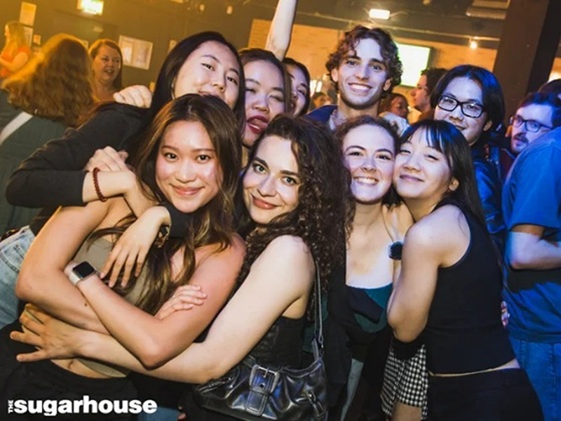 A group of students smiling for a photo at Sugarhouse nightclub in Lancaster.