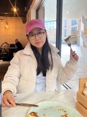 Cath smiling enjoying her pancake brunch in Deli, a restaurant on campus.