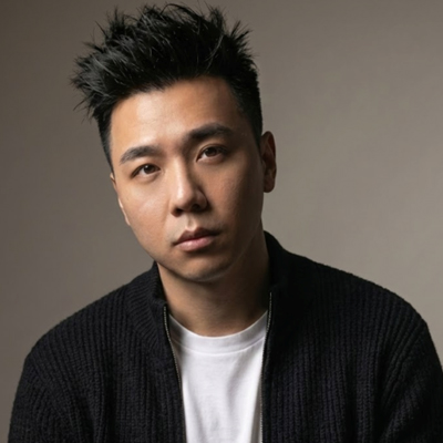 A short haired man looking towards camera