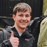 Close up of Ben Evans smiling with a thumbs up to the camera