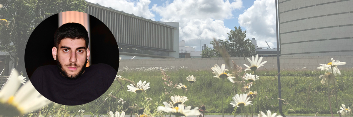 Profile image of student Panagiotis, with a background image of a green space on campus.