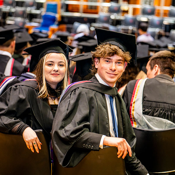 Graduating students, turning arround looking at the camera.