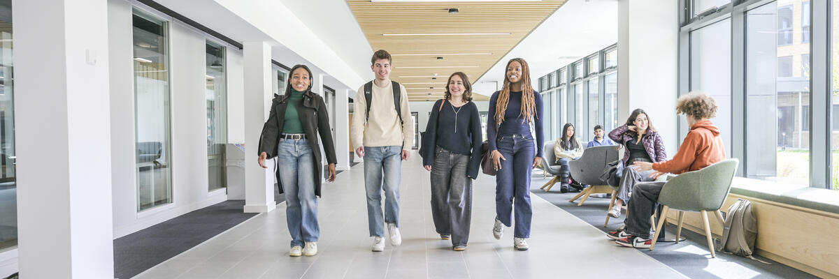 Students walking along a corridor chatting