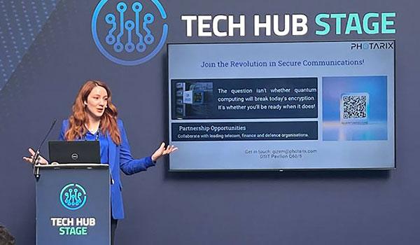 A woman gives a presentation speaking at a technology conference